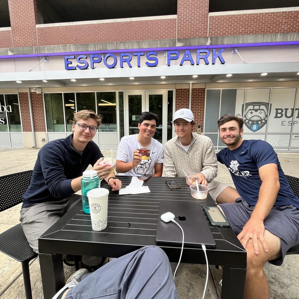 Friends with Chimba bowls at a table outside the Esports Park